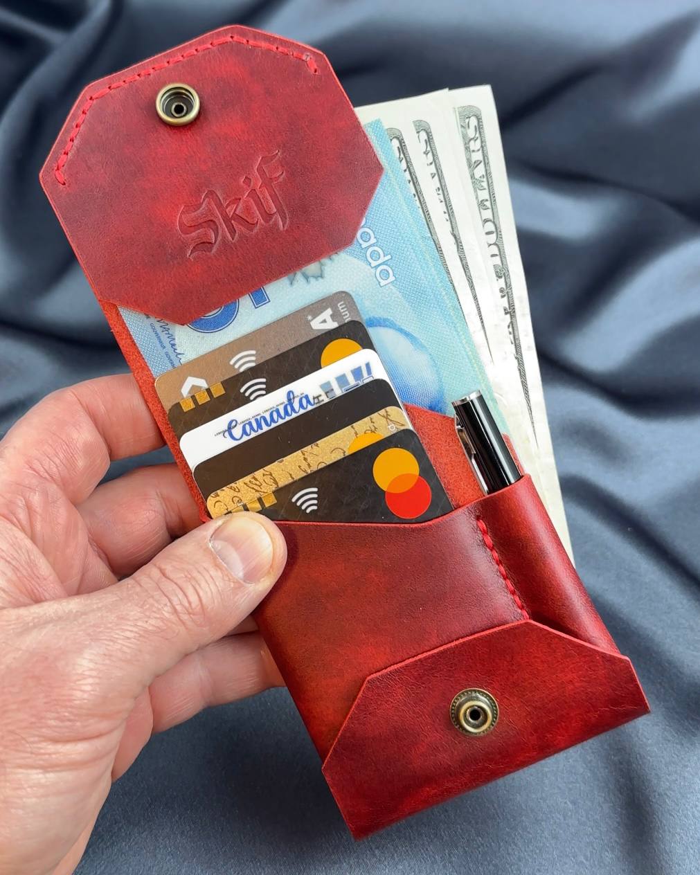 compact leather wallet open with cards and cash ATLAS model