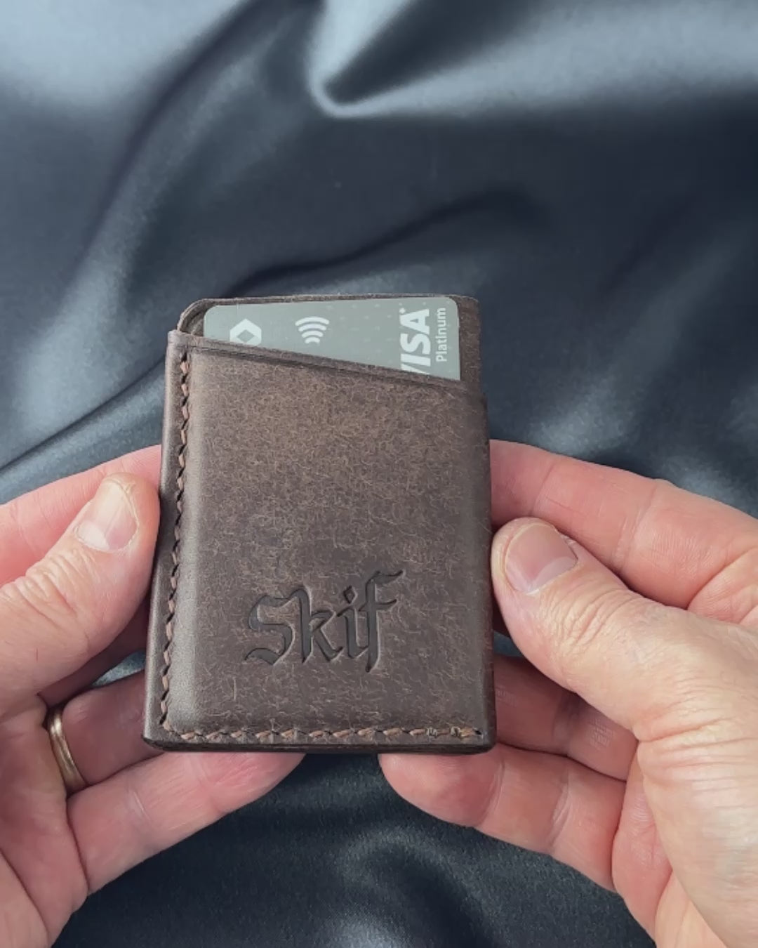 leather card holder in hands usage demonstration SOLO model video